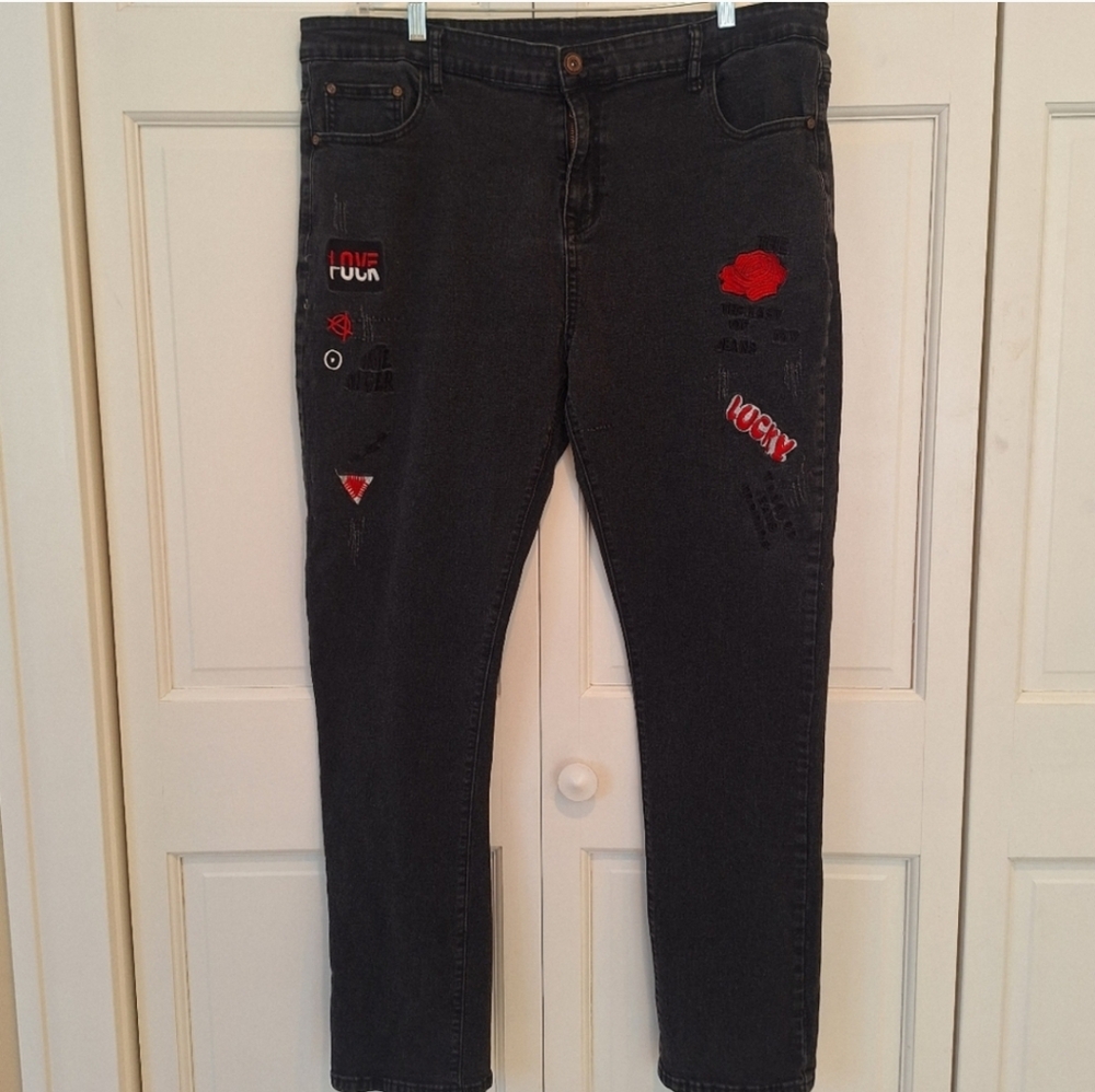 Black denim jeans with embroidered legs